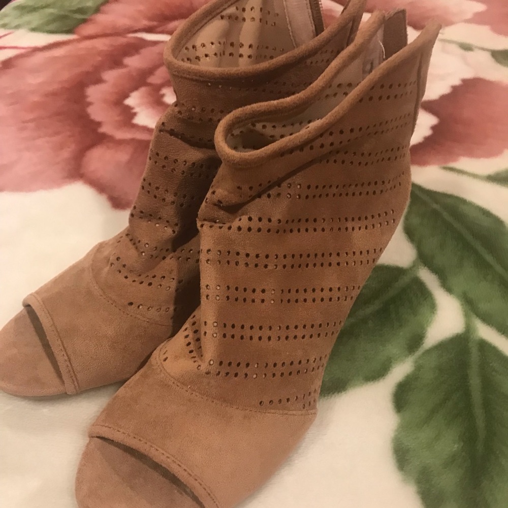 Tan booties that have never been worn before.